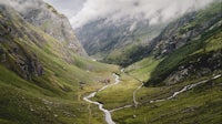 an aerial view of a valley with a river running through it